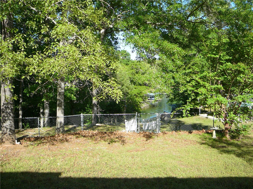 11 Waterford Point Iva, SC 29655 - Photo 27 of 27 This serene lakeside property offers tranquil water views and a lush green landscape.