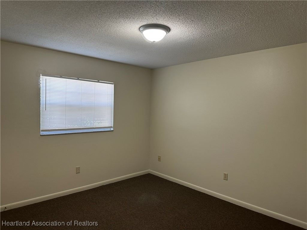 7422 Valencia Road Sebring, FL 33876 - Photo 13 of 15 an empty room with a window