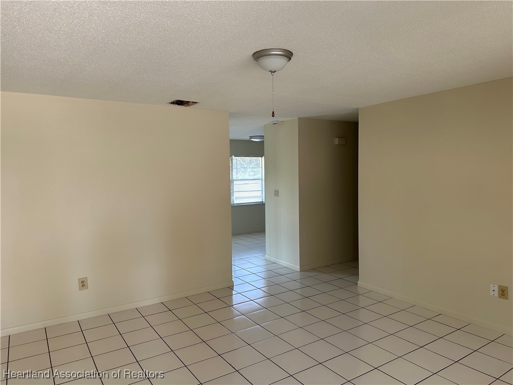 7422 Valencia Road Sebring, FL 33876 - Photo 3 of 15 a view of an empty room and window