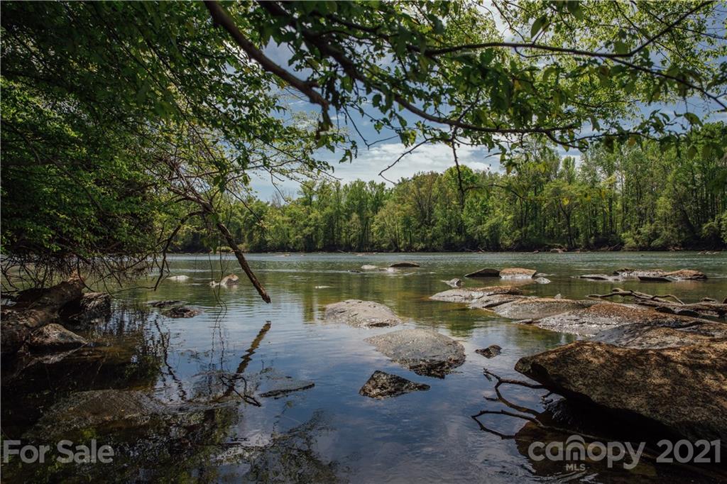 2038 Suttonview Road, Unit 688 Fort Mill, SC 29708 - Photo 12 of 12 a view of a lake with a yard and a large tree