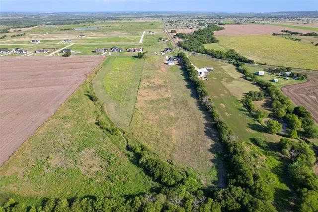 a view of a field with an ocean view