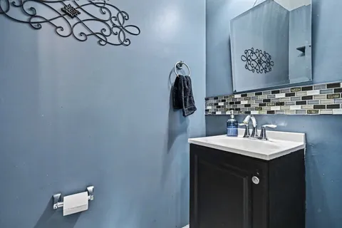 a bathroom with a sink vanity and a mirror
