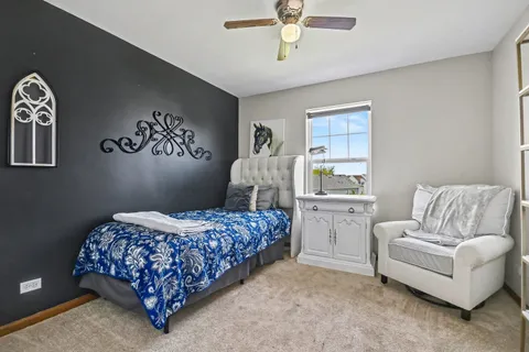 a bedroom with two beds and painting on the wall