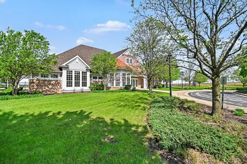a view of a house with yard and sitting area