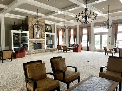 a large living room with furniture or chandelier and a large window