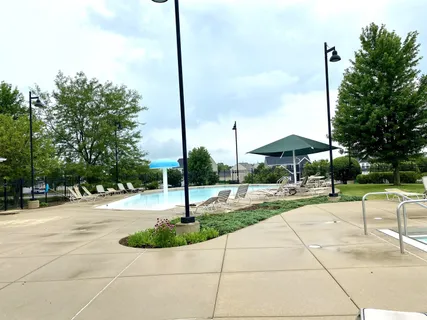 a swimming pool with yard and outdoor seating
