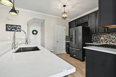 a kitchen with granite countertop a refrigerator and a sink