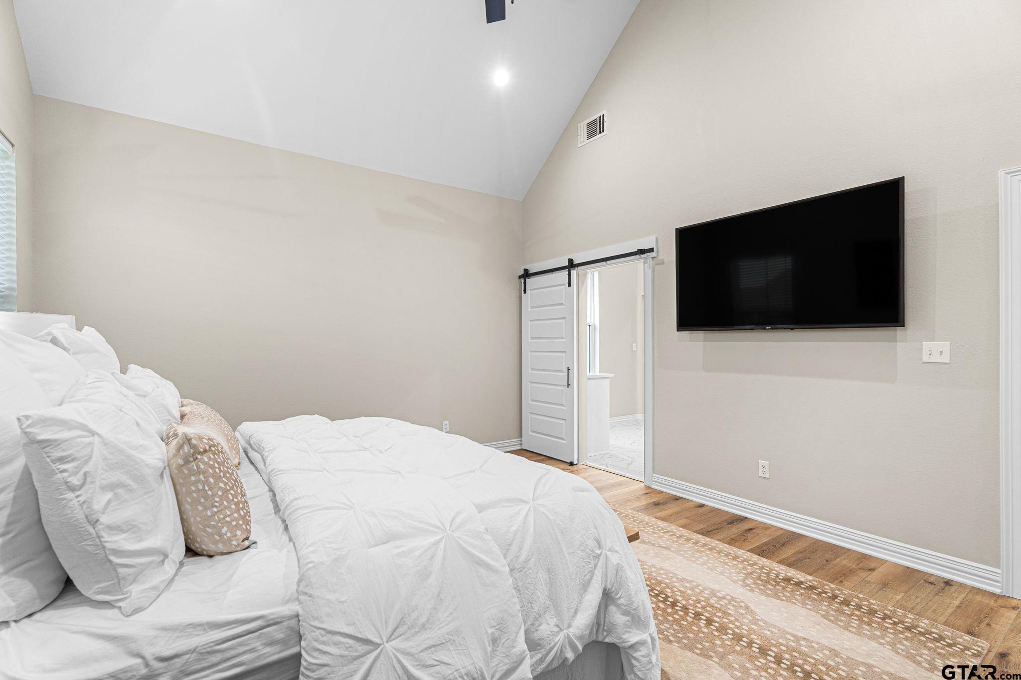 12293 Harlon Street Flint, TX 75762 - Photo 13 of 33 a bedroom with a bed and a flat screen tv