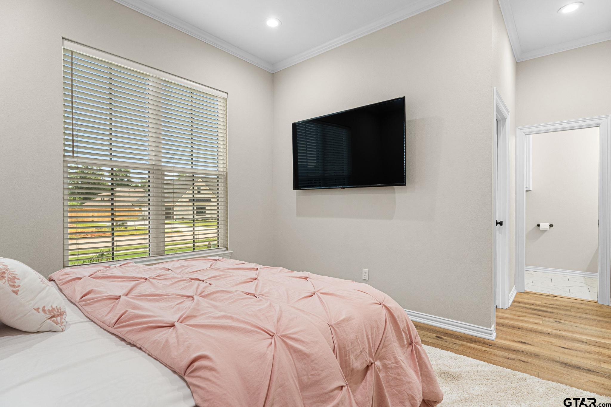 12293 Harlon Street Flint, TX 75762 - Photo 18 of 33 a bedroom with a bed and a flat screen tv