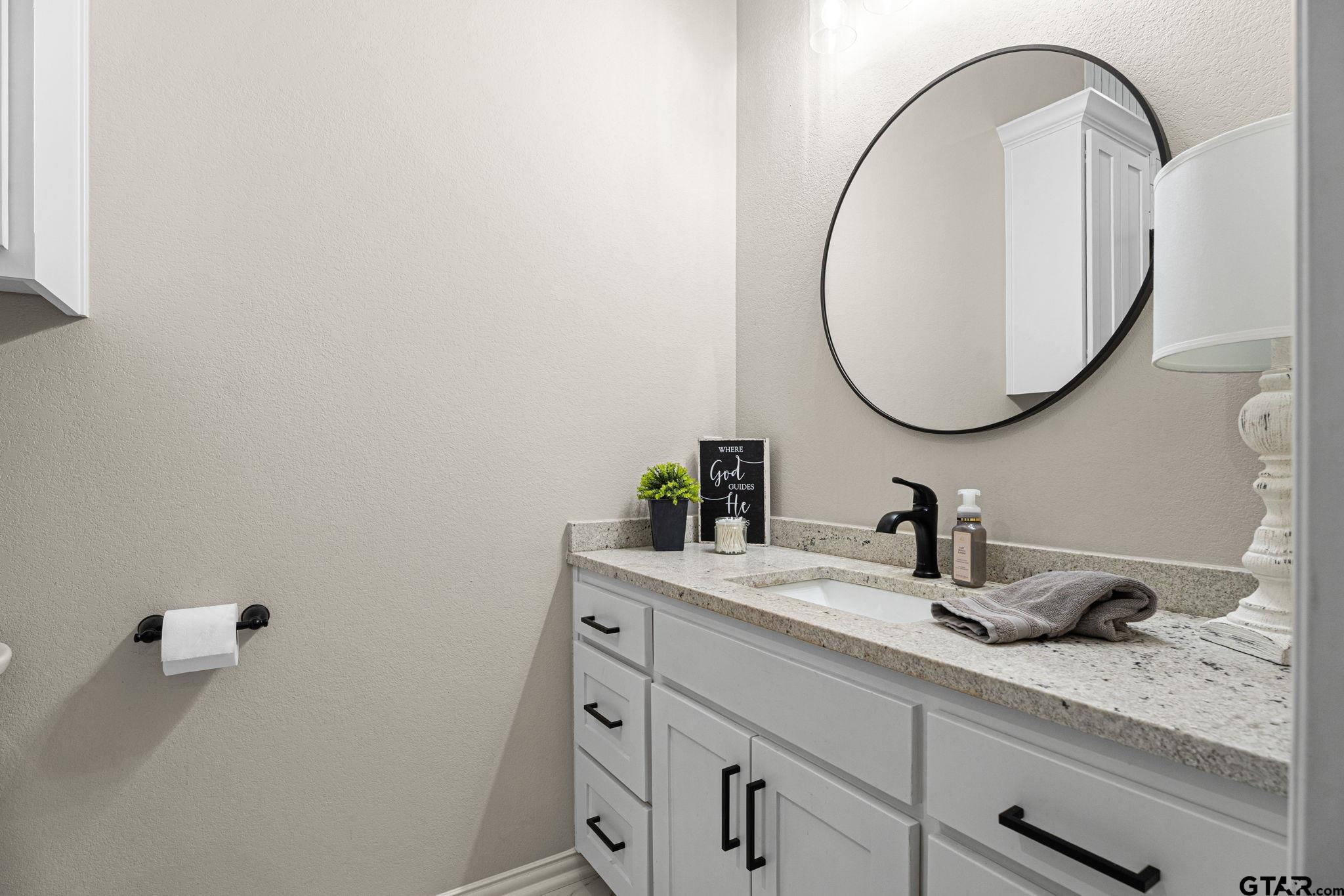 12293 Harlon Street Flint, TX 75762 - Photo 21 of 33 a bathroom with a sink and a mirror