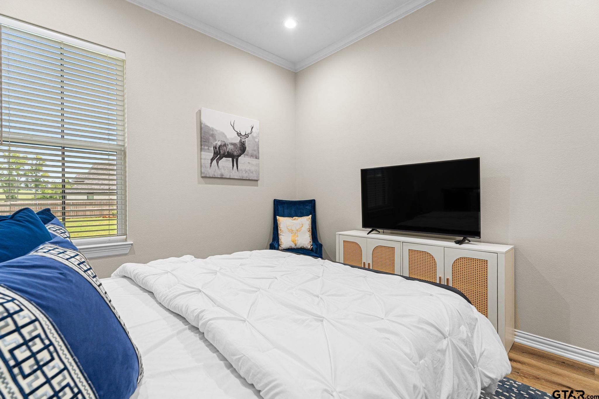 12293 Harlon Street Flint, TX 75762 - Photo 24 of 33 a bedroom with a bed and a flat screen tv