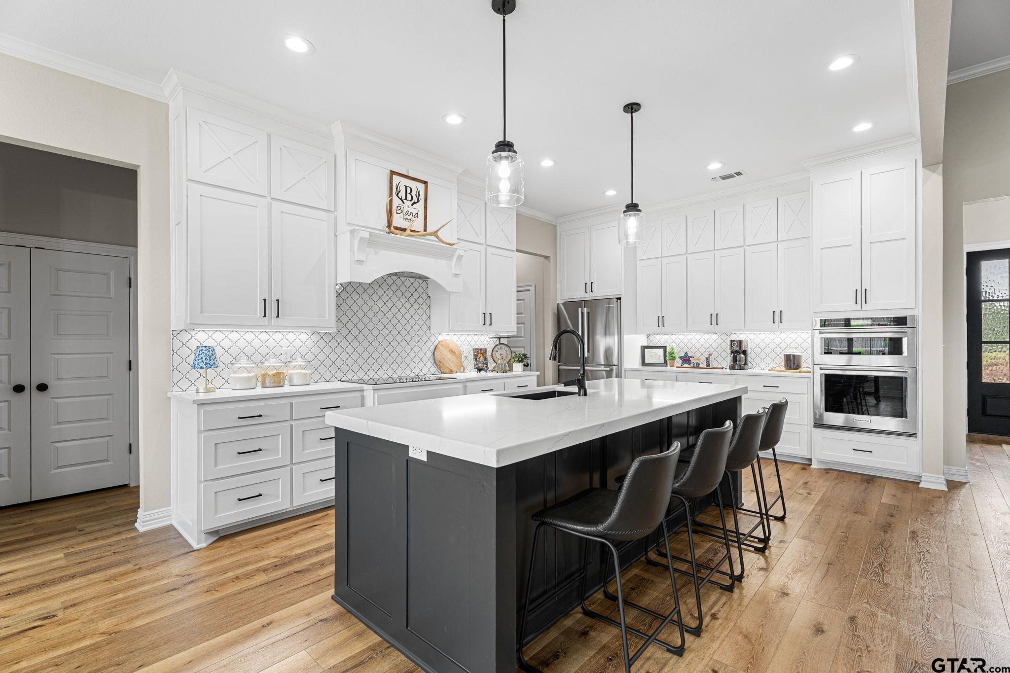12293 Harlon Street Flint, TX 75762 - Photo 8 of 33 a kitchen with kitchen island granite countertop a sink cabinets and wooden floor