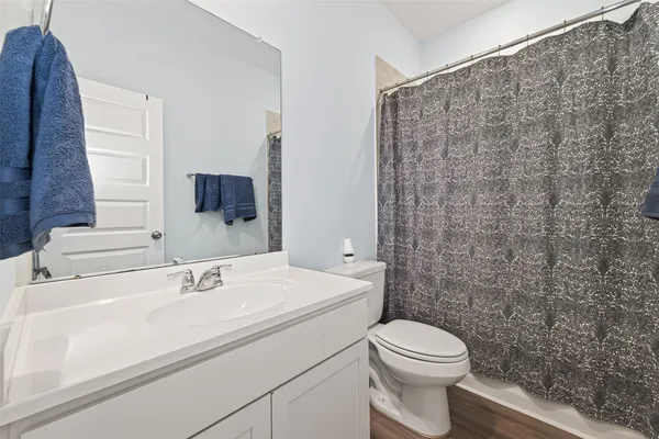 a bathroom with a sink a toilet and a mirror