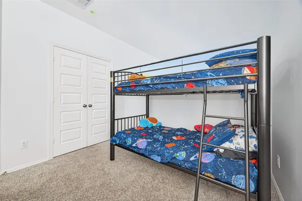 a bedroom with a bed and a furniture