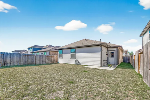 a view of a house with a yard and fence