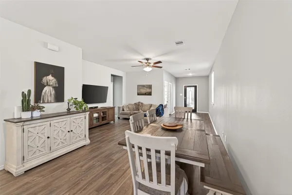 a view of a dining room with furniture and a flat screen tv