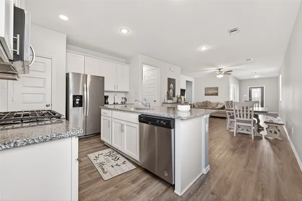 a kitchen with refrigerator and cabinets