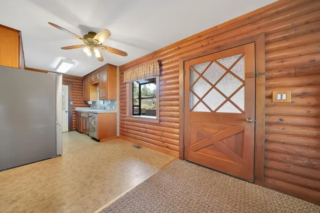 a view of a room with wooden floor and a cabinet