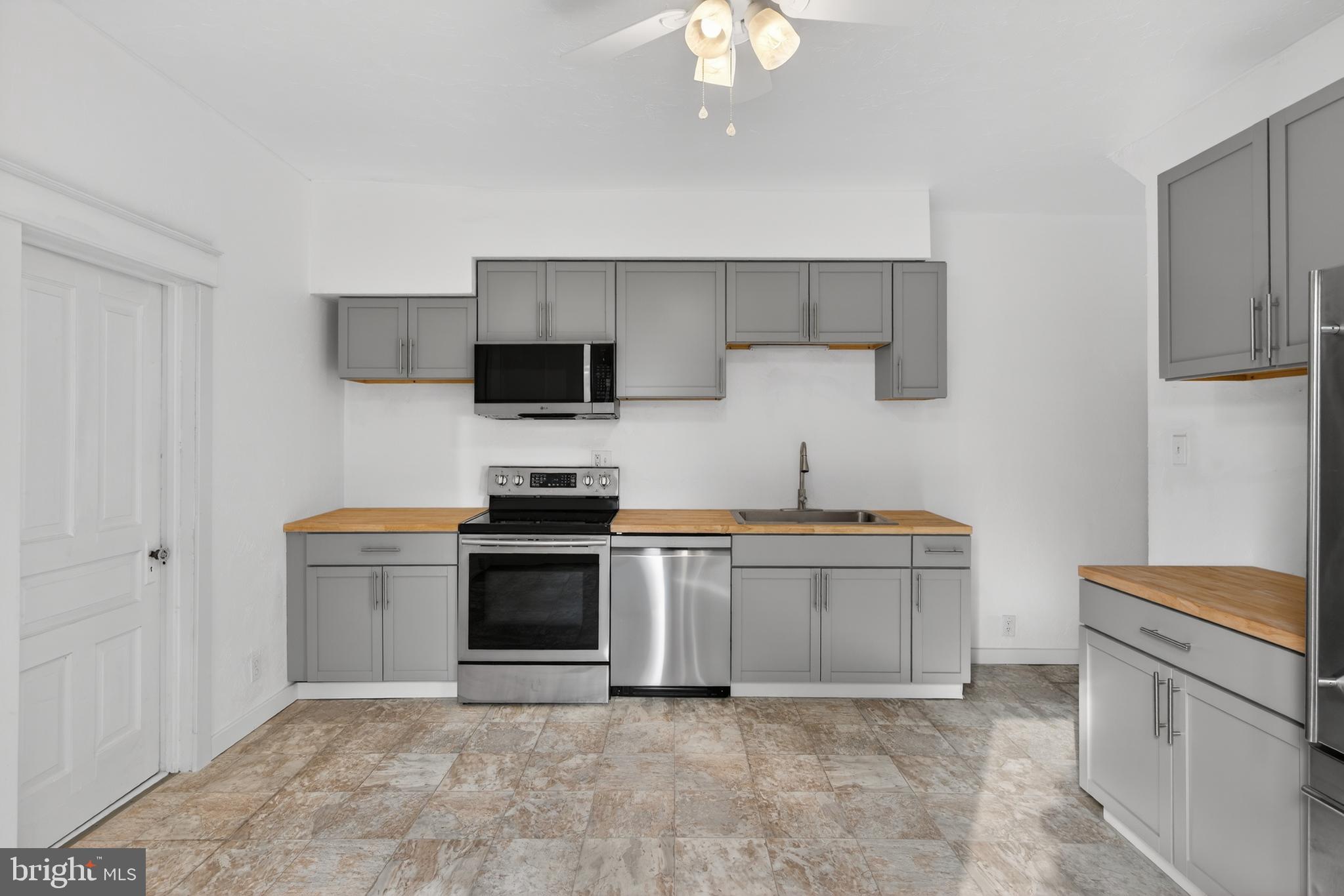 202 South Main Street Red Lion, PA 17356 - Photo 13 of 39 a kitchen with stainless steel appliances granite countertop a stove and a sink