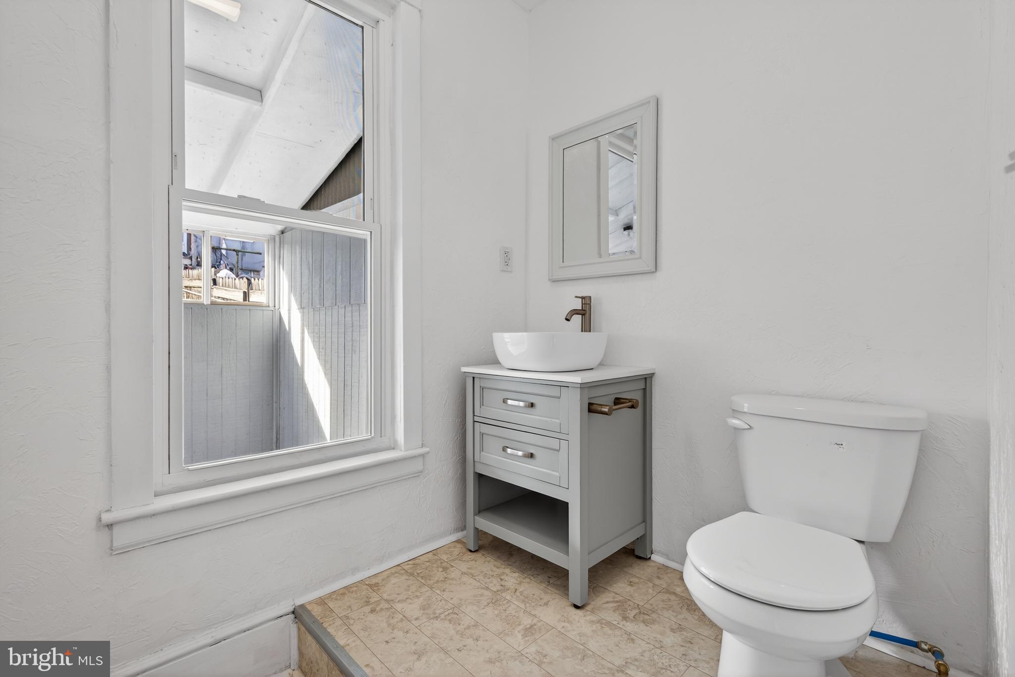 202 South Main Street Red Lion, PA 17356 - Photo 16 of 39 a bathroom with a toilet sink and mirror