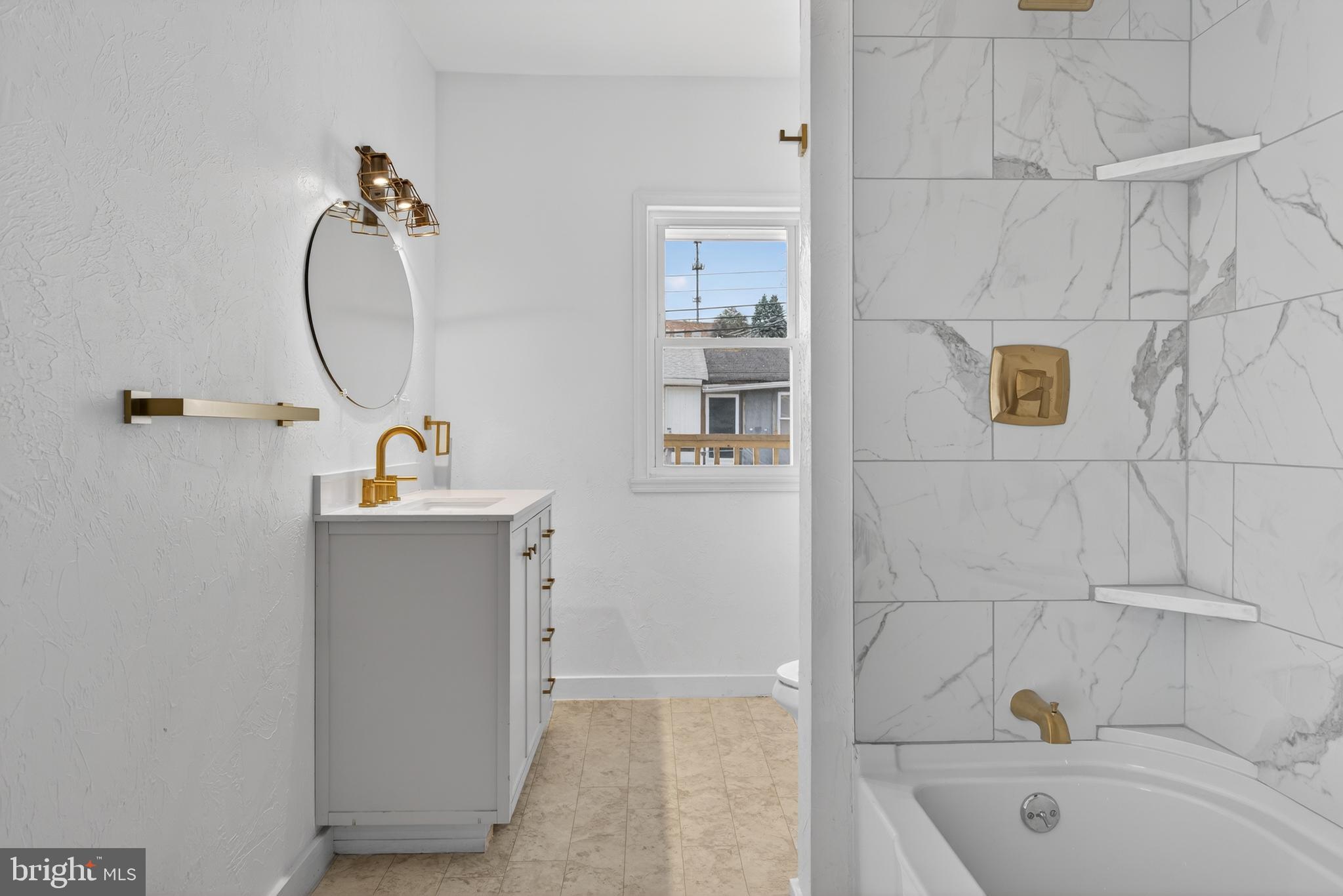 202 South Main Street Red Lion, PA 17356 - Photo 26 of 39 a bathroom with a tub a sink and mirror
