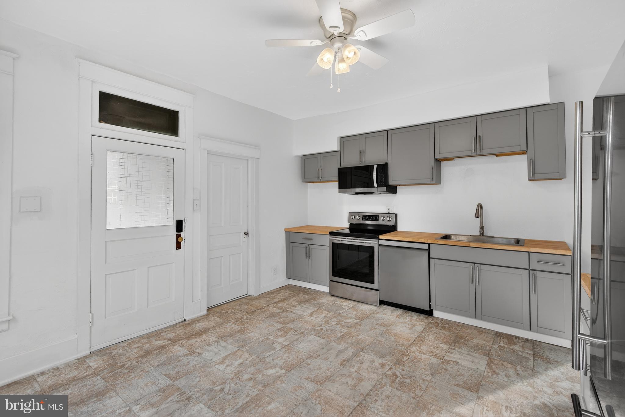 202 South Main Street Red Lion, PA 17356 - Photo 9 of 39 a kitchen with a refrigerator and a stove top oven