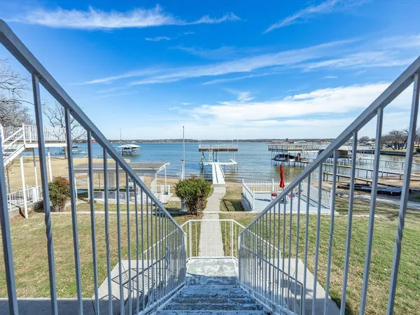 a view of staircase with railing and white walls