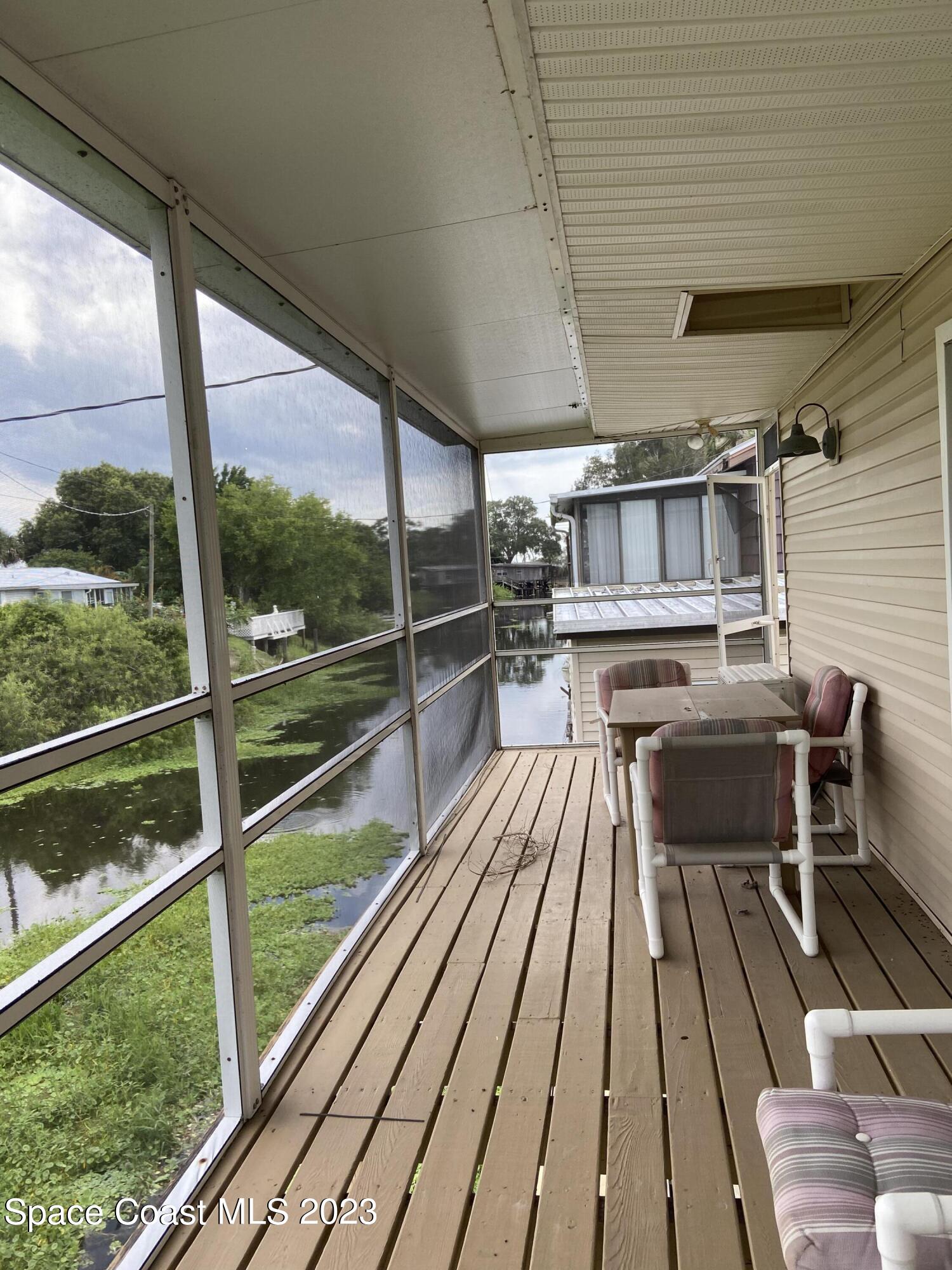 5757 Lake Poinsett Road Cocoa, FL 32926 - Photo 11 of 43 a view of balcony with chairs and wooden floor