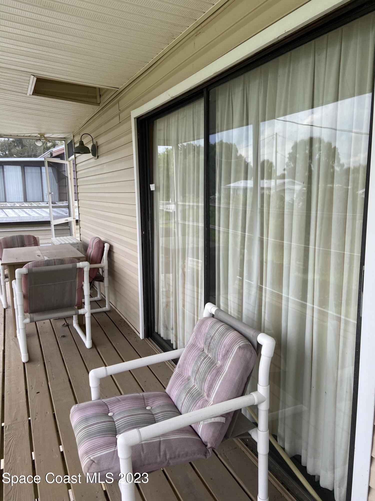 5757 Lake Poinsett Road Cocoa, FL 32926 - Photo 12 of 43 a view of balcony with two chairs and a potted plant