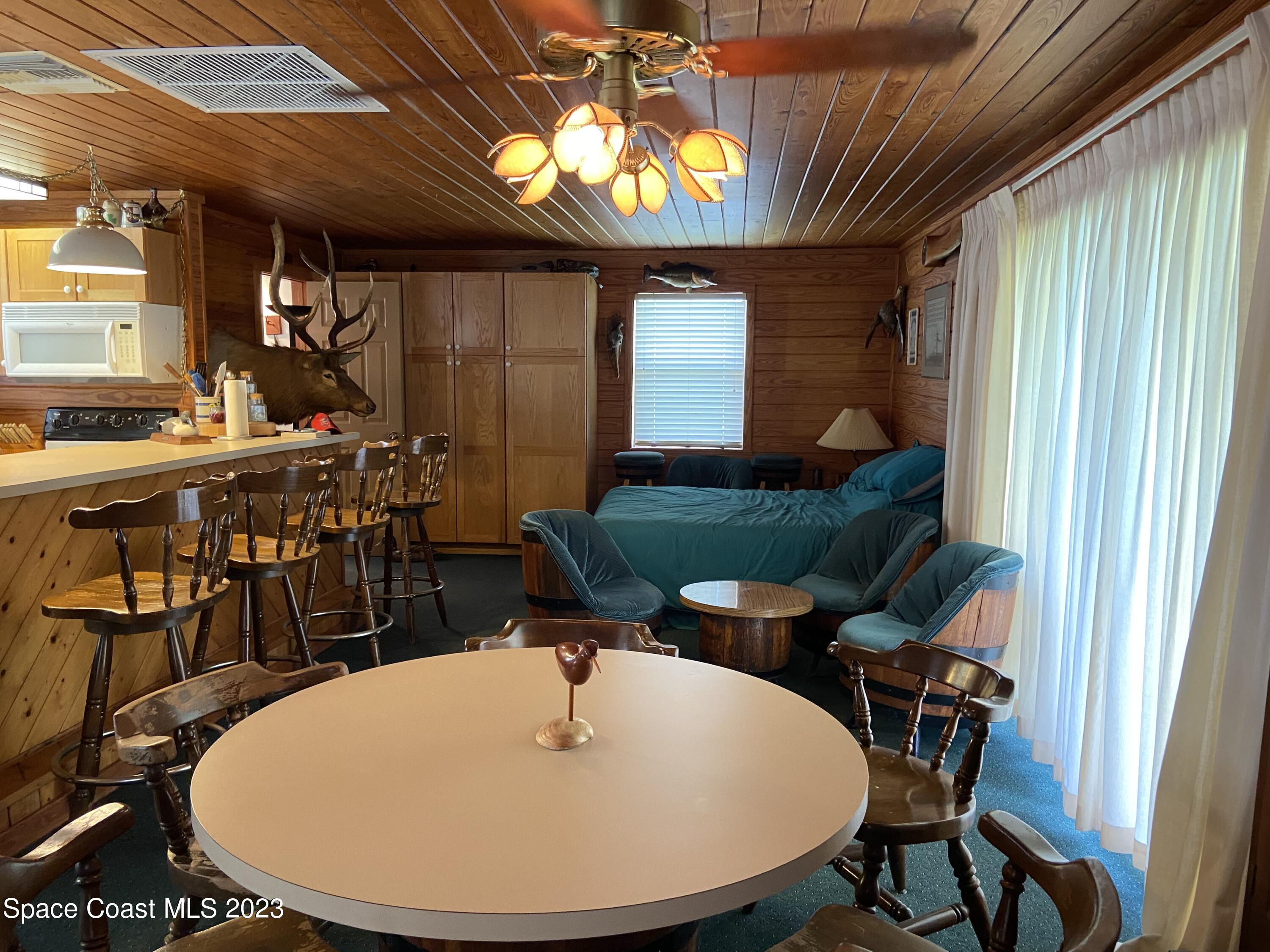5757 Lake Poinsett Road Cocoa, FL 32926 - Photo 17 of 43 a view of a dining room with furniture and window