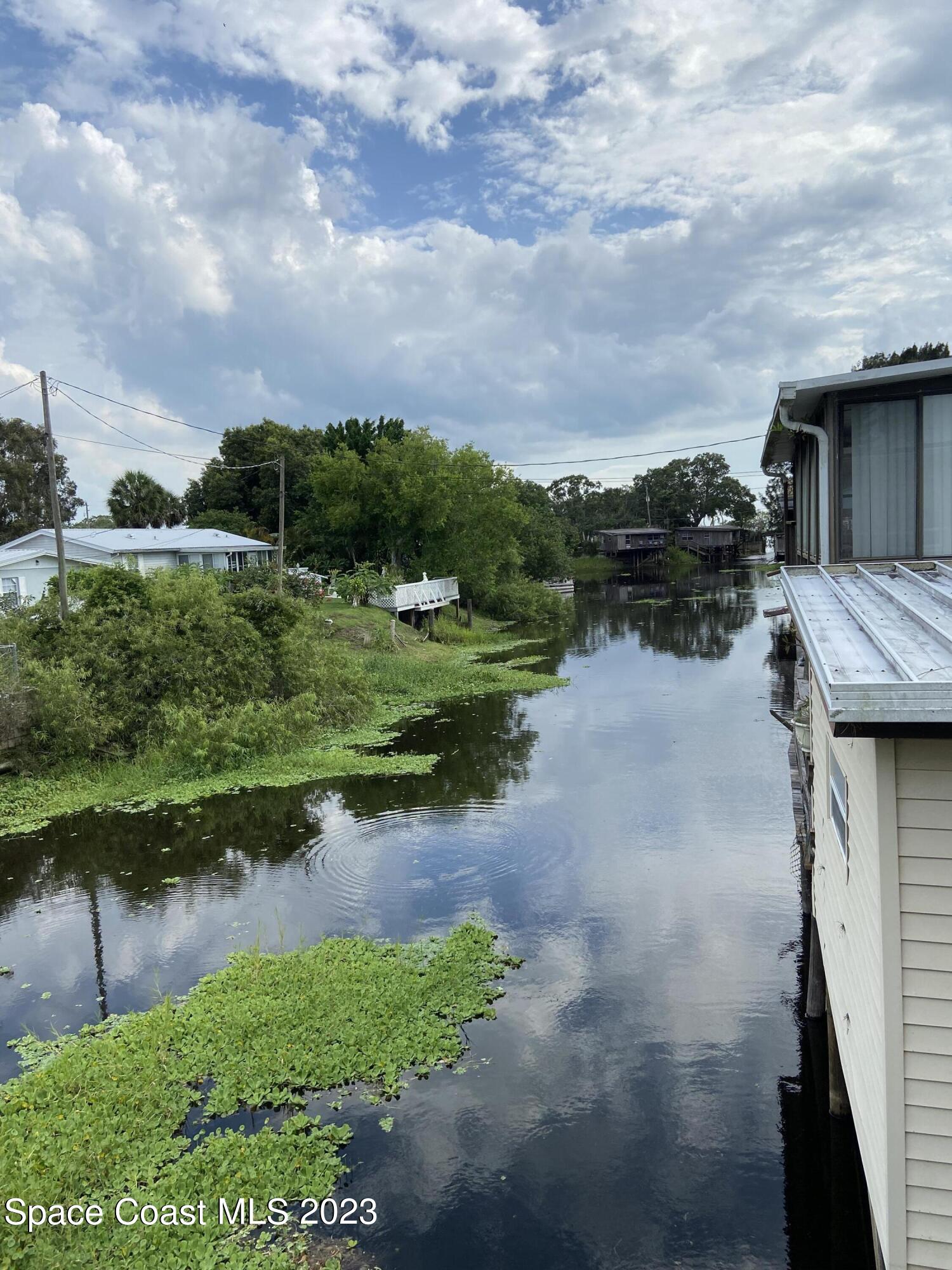 5757 Lake Poinsett Road Cocoa, FL 32926 - Photo 2 of 43 a view of a lake with houses in the back