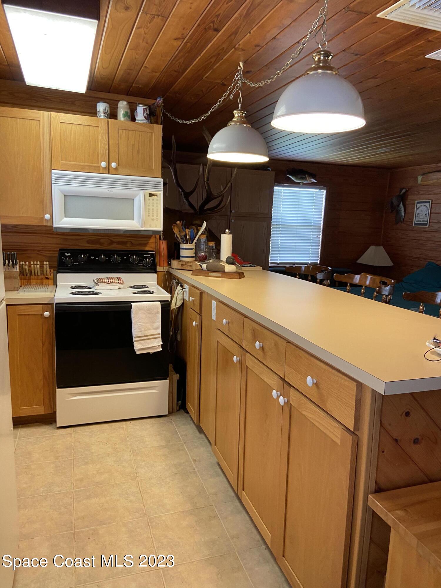 5757 Lake Poinsett Road Cocoa, FL 32926 - Photo 24 of 43 a kitchen with a stove and a microwave