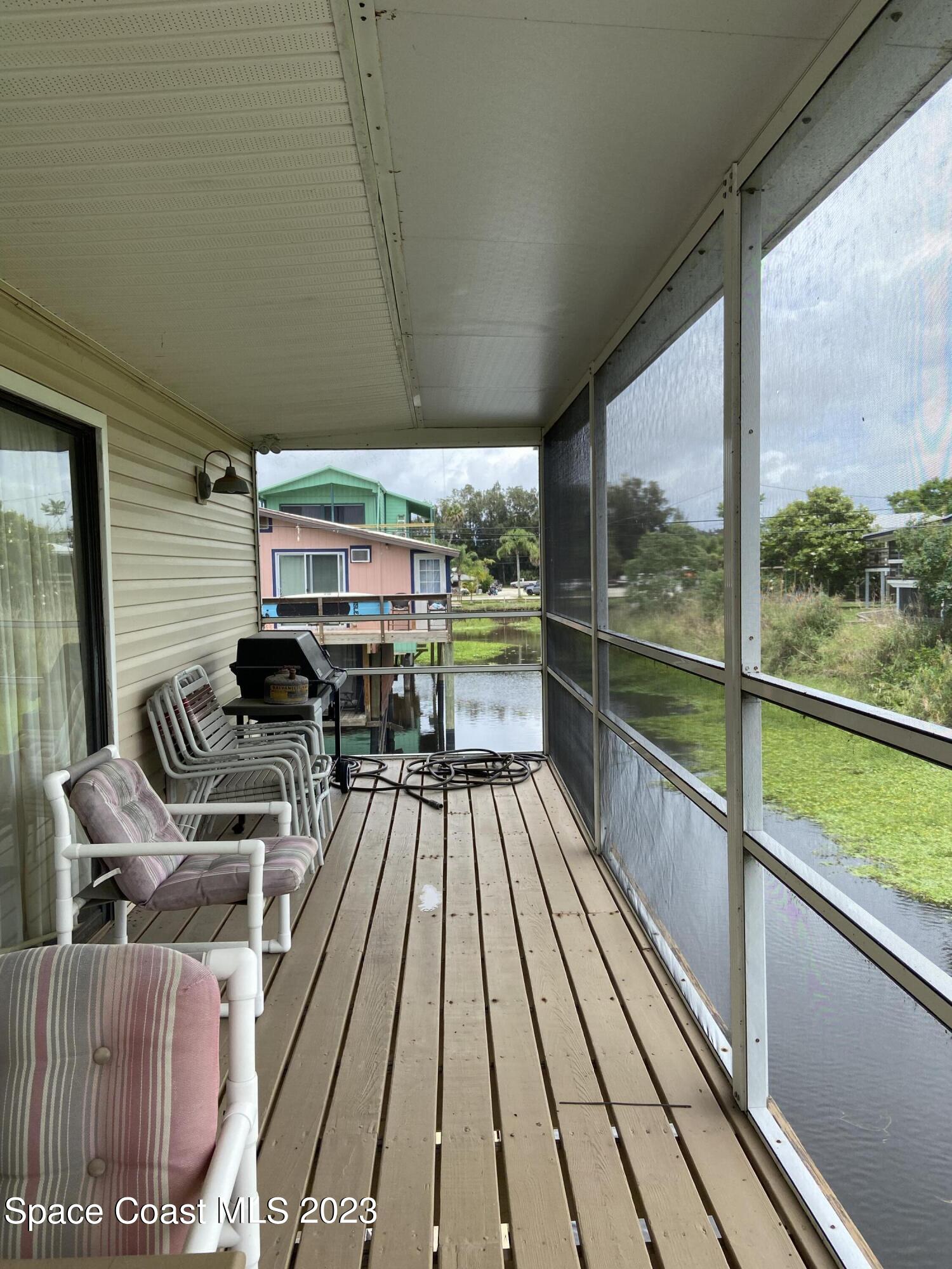 5757 Lake Poinsett Road Cocoa, FL 32926 - Photo 43 of 43 a view of balcony with chairs and wooden floor