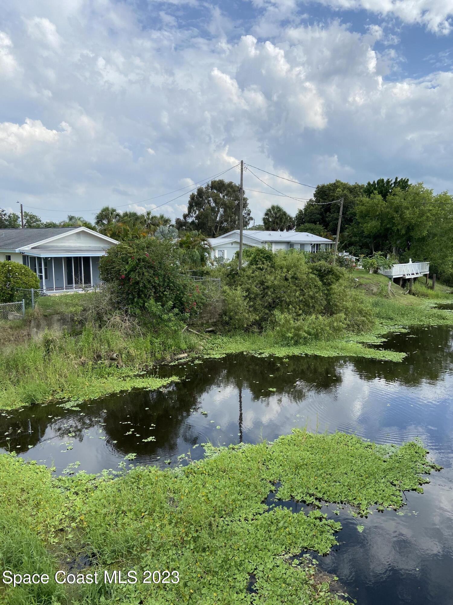 5757 Lake Poinsett Road Cocoa, FL 32926 - Photo 5 of 43 a view of a lake with a house in the background