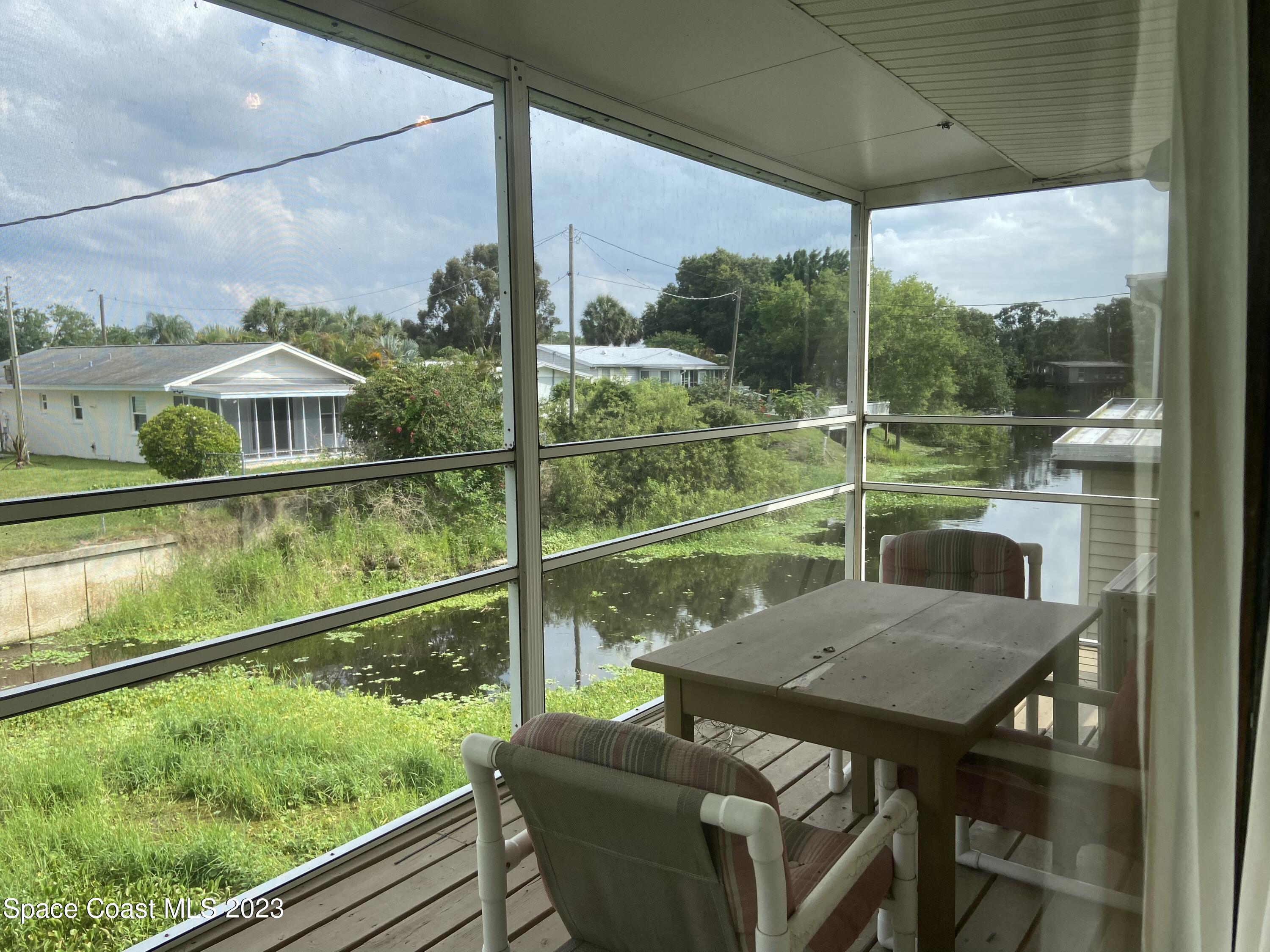5757 Lake Poinsett Road Cocoa, FL 32926 - Photo 8 of 43 a view of a porch with furniture and yard