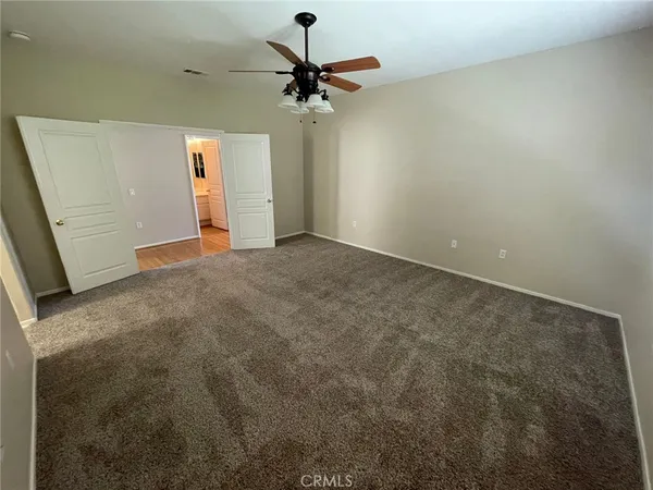 a view of a room with a ceiling fan