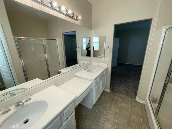 a bathroom with a double vanity sink and mirror