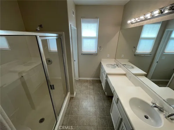 a bathroom with a sink a mirror and a shower