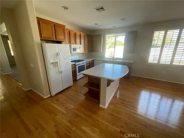 a kitchen with sink refrigerator and window