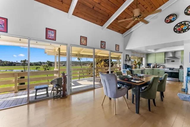 a dining area with furniture and a floor to ceiling window