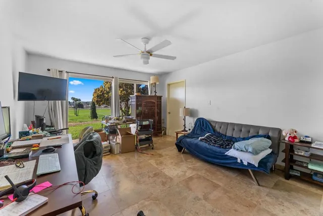 a living room with furniture a air conditioner vent and a window