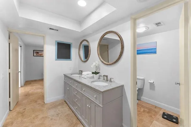 a bathroom with a sink a mirror and a toilet