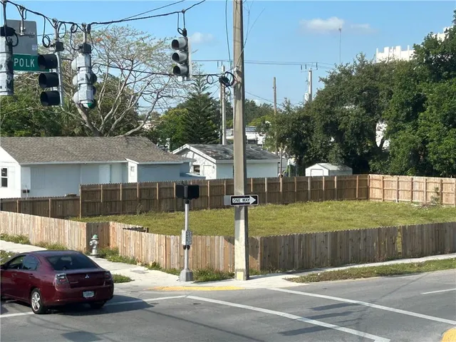 a view of a street that has parked cars