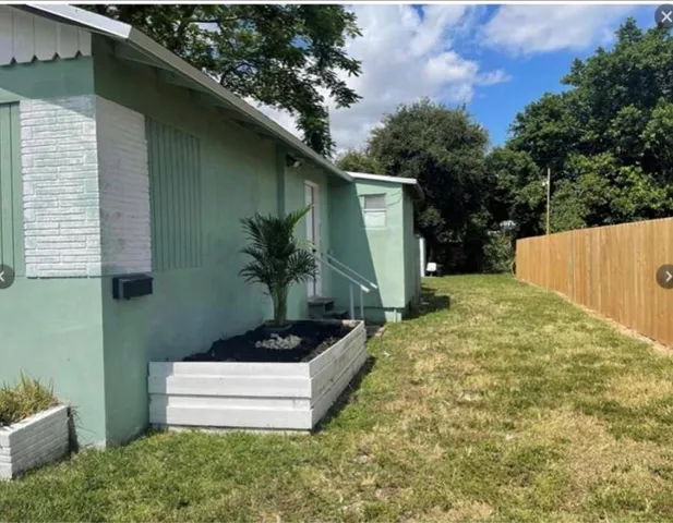a backyard of a house with plants