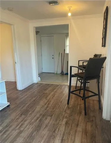 a view of a workspace room with wooden floor and chair