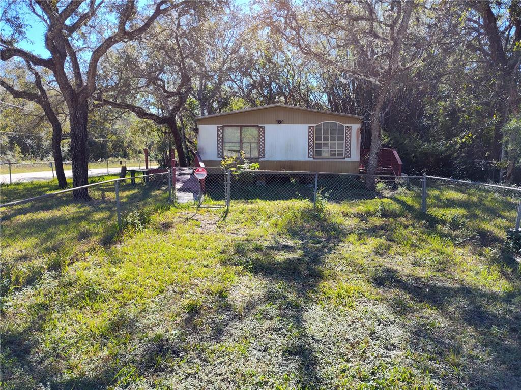 a view of a house with a yard patio and fire pit
