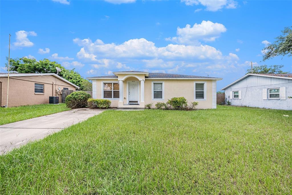 a view of a house with backyard and sitting area