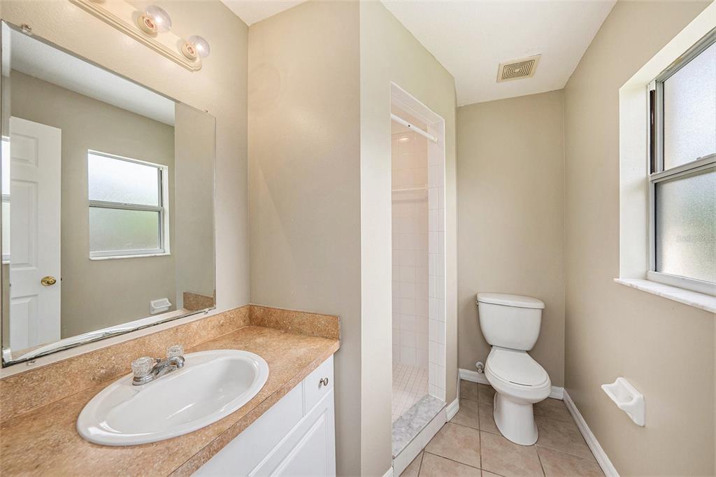 5850 13th Avenue New Port Richey, FL 34652 - Photo 13 of 15 a bathroom with a toilet sink and mirror