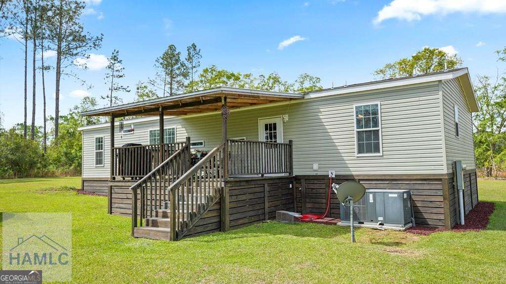 876 Hires Road Jesup, GA 31545 - Photo 26 of 30 a view of a house with a yard