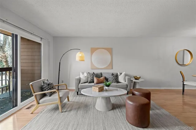 a living room with furniture a mirror and a potted plant